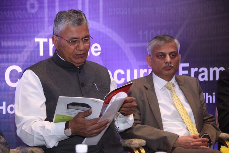Shri. P.P. Chaudhary, MoS for Electronics & IT, Law & Justice, Govt of India going through the Handbook on Cyber security
